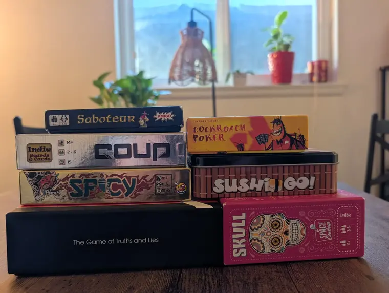 A picture of a stack of card games in their boxes.